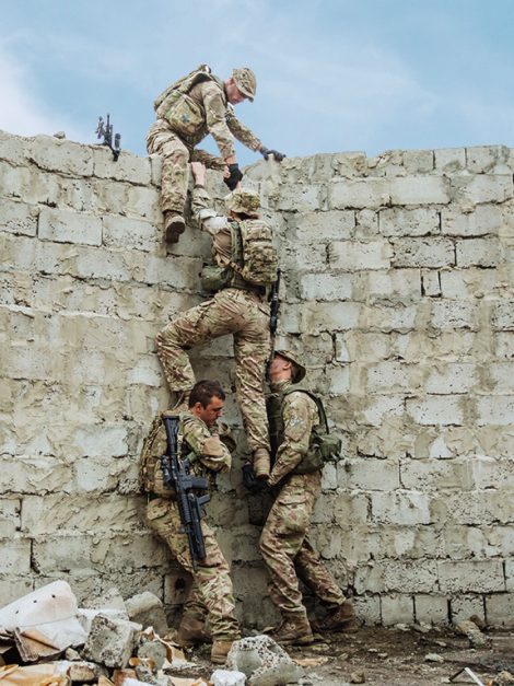 troops climbing over wall